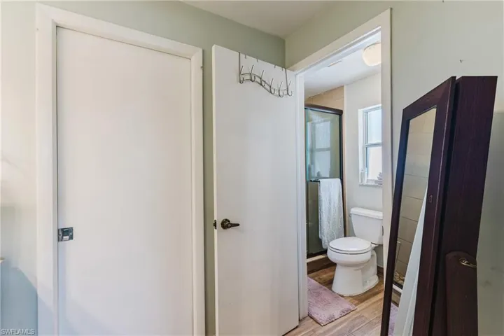 Bathroom with a shower stall and light wood-type flooring