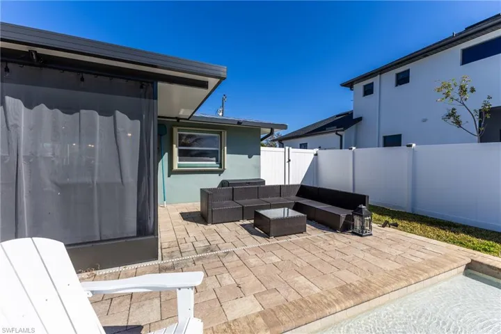 Fenced backyard featuring a patio area and an outdoor lounge area