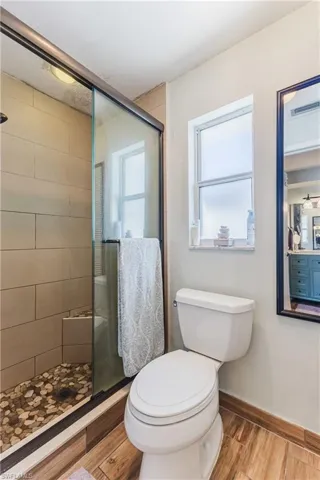 Bathroom featuring a stall shower and wood finished floors