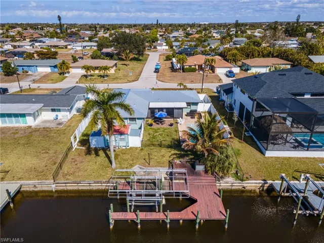 Aerial perspective of suburban area with a nearby body of water