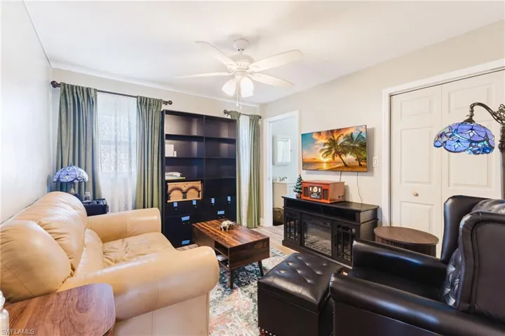 Living room featuring ceiling fan and plenty of natural light