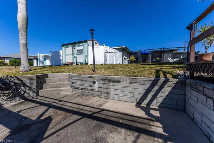 View of community featuring a storage unit and a patio area