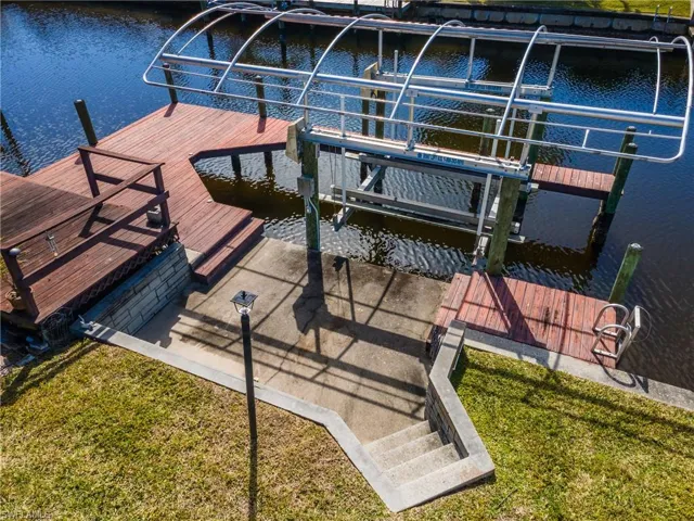Dock area with boat lift and a water view