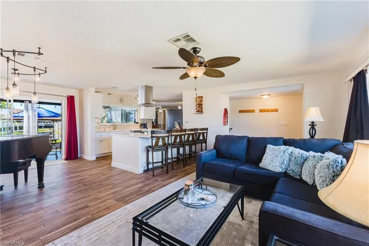 Living area featuring wood finished floors and a ceiling fan