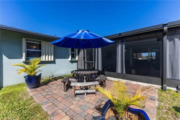 View of patio / terrace with a sunroom and outdoor dining space