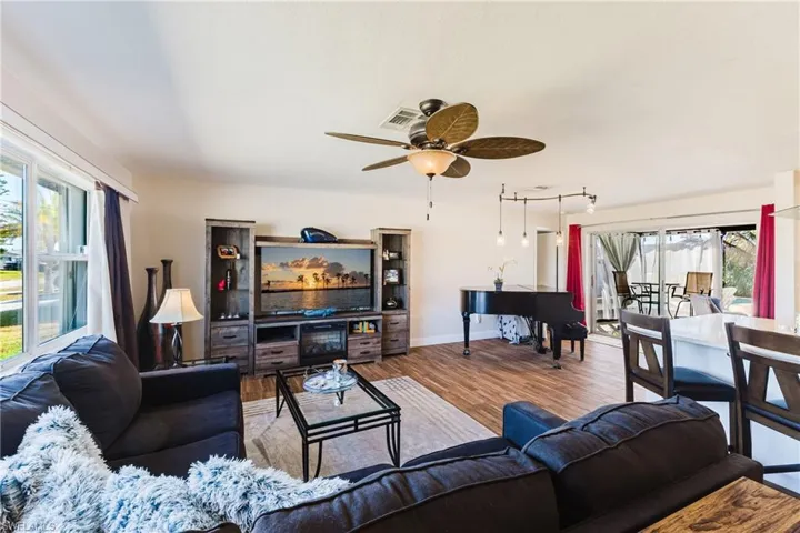 Living room featuring ceiling fan and wood finished floors