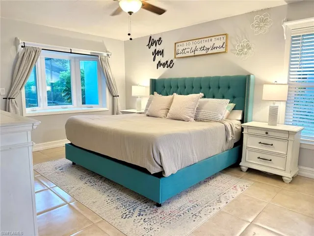 Bedroom featuring light tile patterned floors and ceiling fan