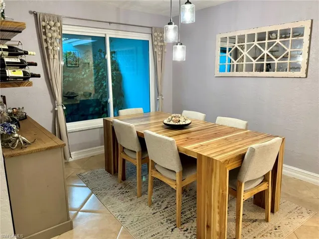 Dining space featuring light tile patterned flooring