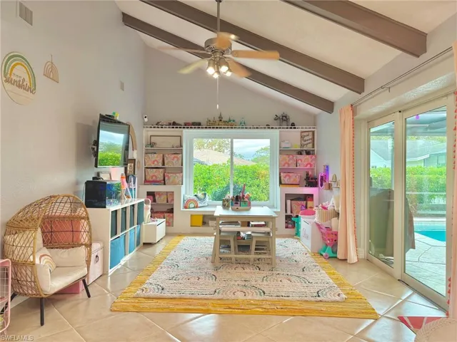 Game room with vaulted ceiling with beams, ceiling fan, and light tile patterned flooring