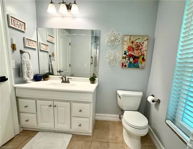 Bathroom with tile patterned floors, vanity, and toilet
