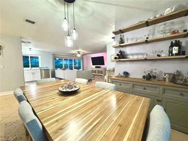 Tiled dining area featuring ceiling fan