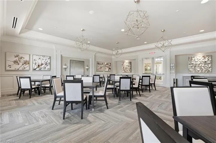 Community Cardroom featuring patterned carpet flooring, recessed lighting, crown molding and contemporary geometric chandeliers.