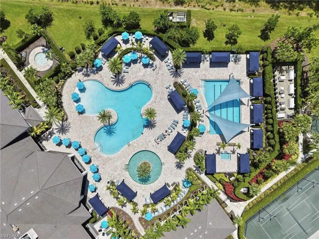 Expansive outdoor amenity area featuring two swimming pools, a spa and tennis courts