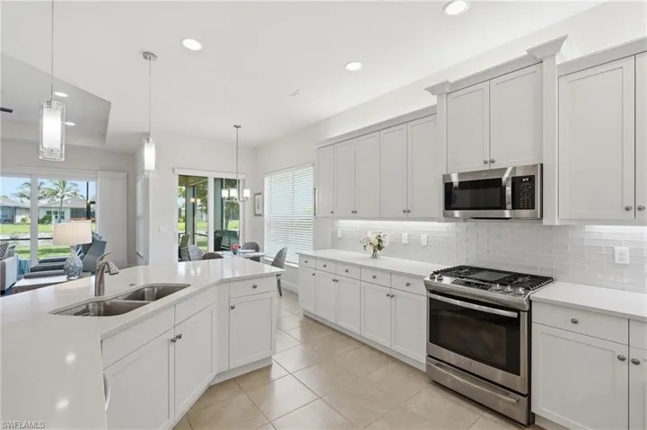 Gourmet kitchen with quartz countertops and white cabinetry.