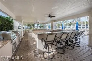 View of patio with a ceiling fan and exterior kitchen