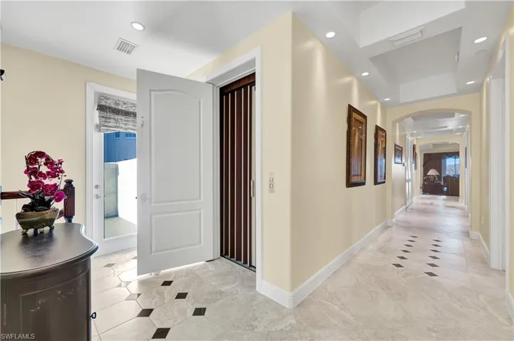 Hallway with arched walkways and recessed lighting