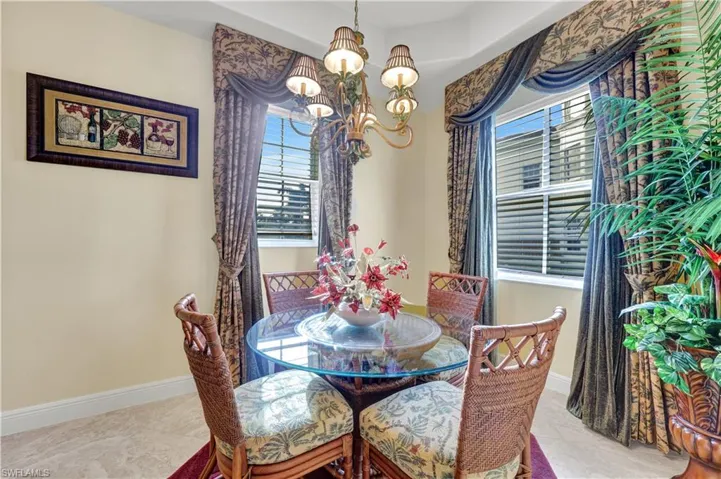 Dining space with a chandelier and baseboards