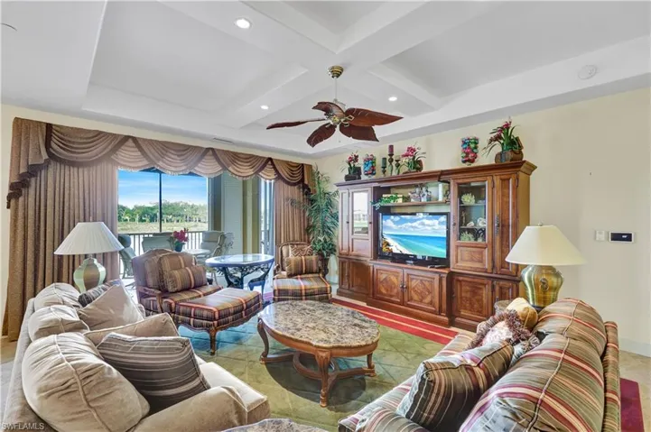 Living room with coffered ceiling, ceiling fan, recessed lighting, and beam ceiling