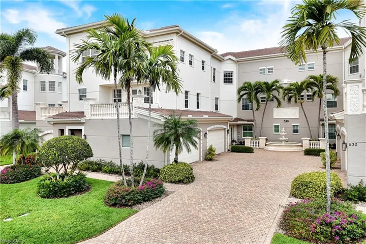 View of property with driveway and a garage