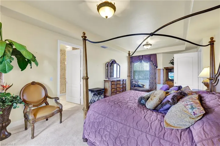Bedroom with ensuite bath and carpet floors