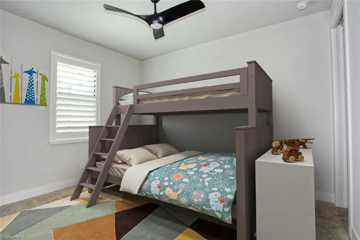Bedroom featuring a white framed window with plantation shutters, a contemporary ceiling fan, and light-toned walls