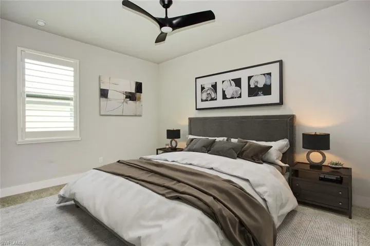 Bedroom featuring a ceiling fan, window with plantation shutters, recessed lighting, and a neutral color palette