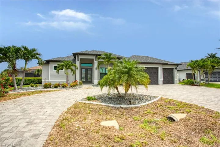 Contemporary exterior with a double-door entry, decorative columns, and a paved driveway