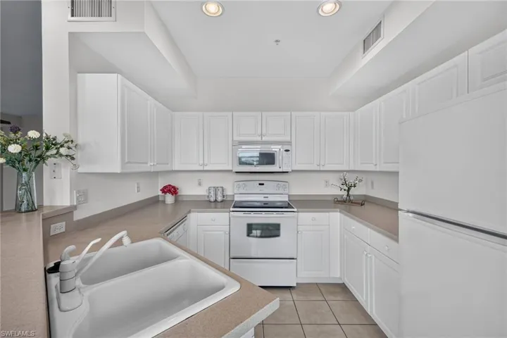 bright, open Kitchen with plenty of cabinet space & recessed lighting