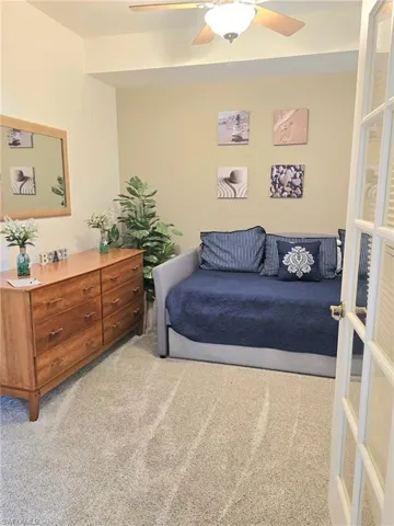 Bedroom with light colored carpet and ceiling fan