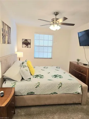 Bedroom with a ceiling fan and carpet flooring