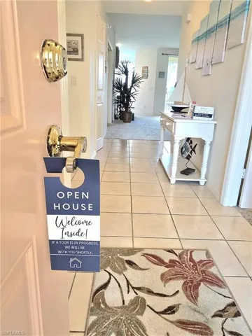 Corridor featuring light tile patterned floors and baseboards