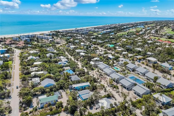 Aerial view of residential area featuring a nearby body of water