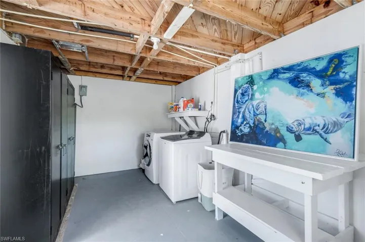 Laundry area with concrete flooring and washer and dryer
