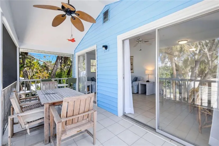 Sunroom featuring ceiling fan, outdoor dining area, and vaulted ceiling