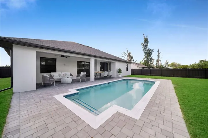 View of pool with an outdoor living space, a patio, and ceiling fan