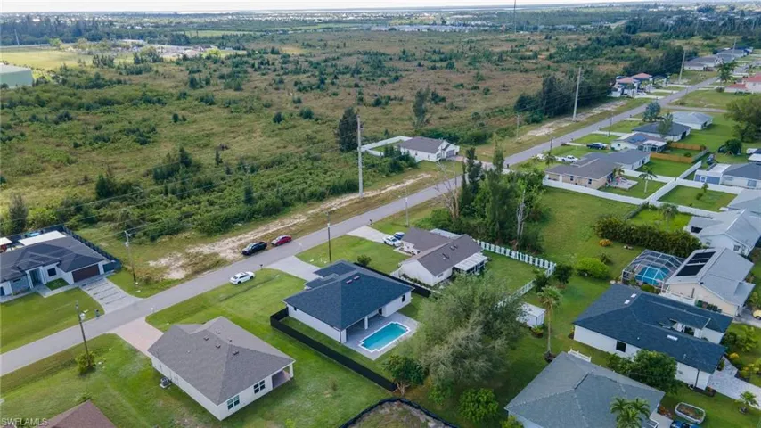 Aerial view of property's location with nearby suburban area