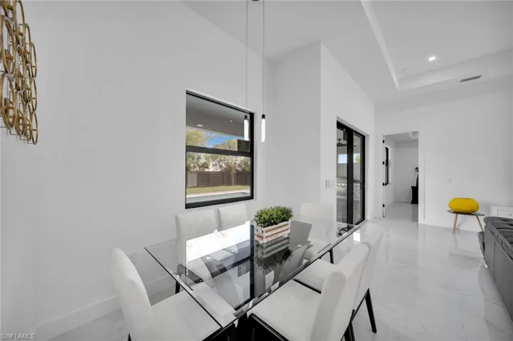 Dining space with light marble finish flooring and baseboards