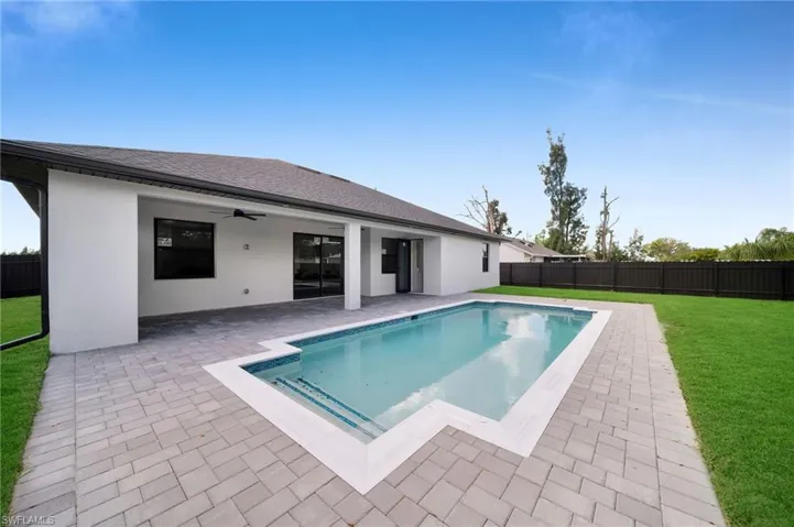 View of swimming pool featuring a patio and ceiling fan