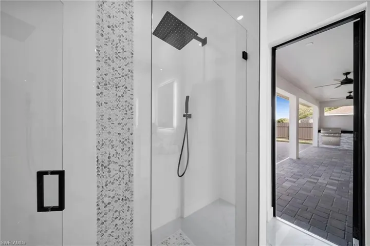 Full bathroom featuring a shower stall and a ceiling fan