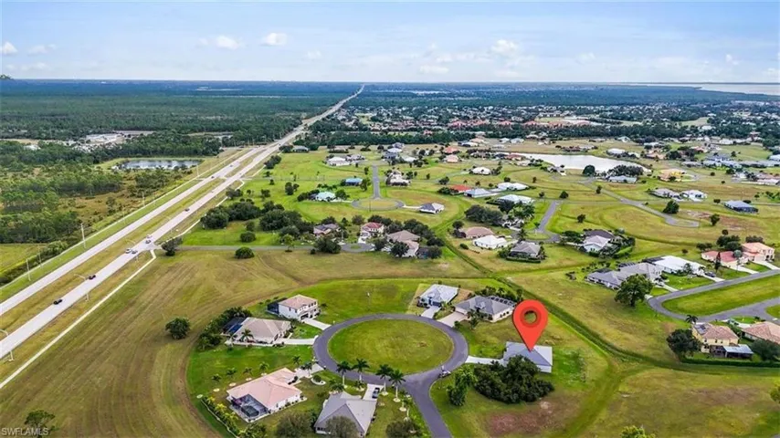 Aerial overview of property's location with nearby suburban area and a large body of water