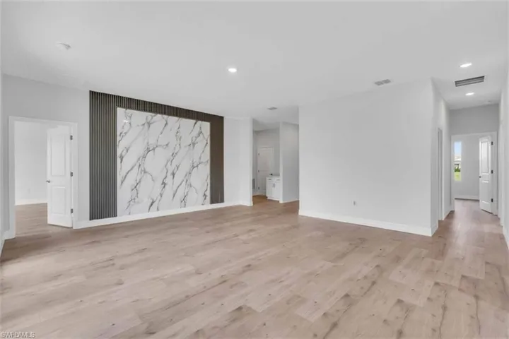 Unfurnished living room with light wood finished floors and recessed lighting