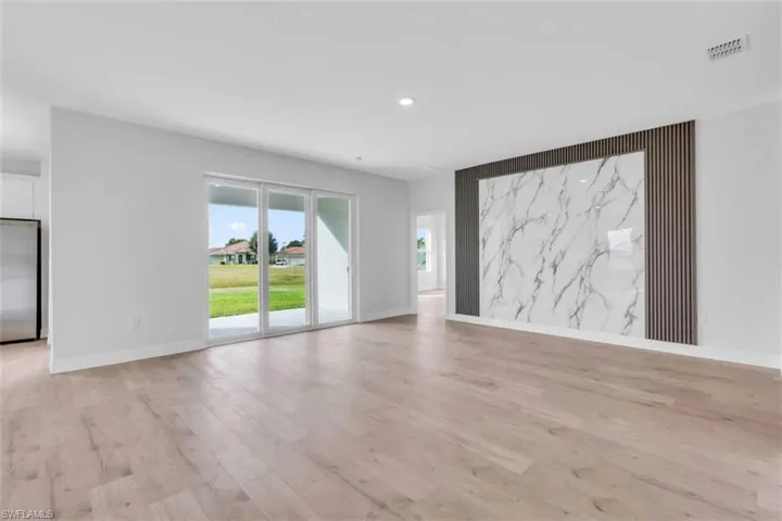 Living room featuring light wood finished floors and sliding doors