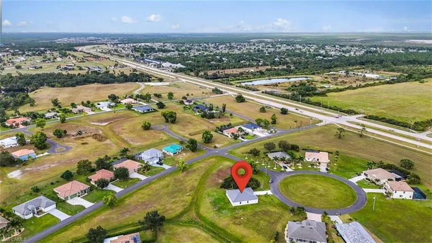 View of property location with nearby suburban area and a nearby body of water