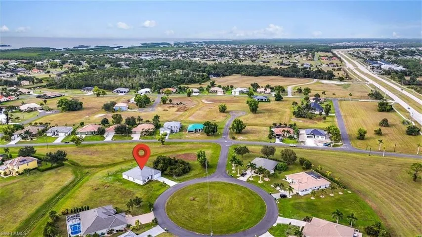 Aerial view of property's location with nearby suburban area