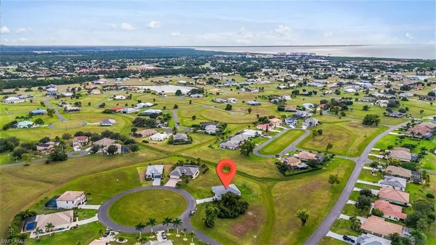 View of property location with nearby suburban area and a nearby body of water