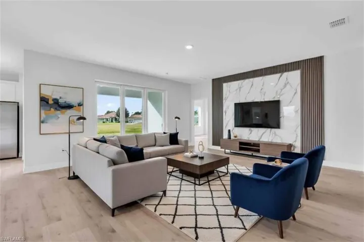 Virtually staged living room featuring light wood-type flooring. Wall design not virtually staged.