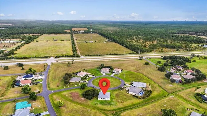 Aerial view of property's location with nearby suburban area