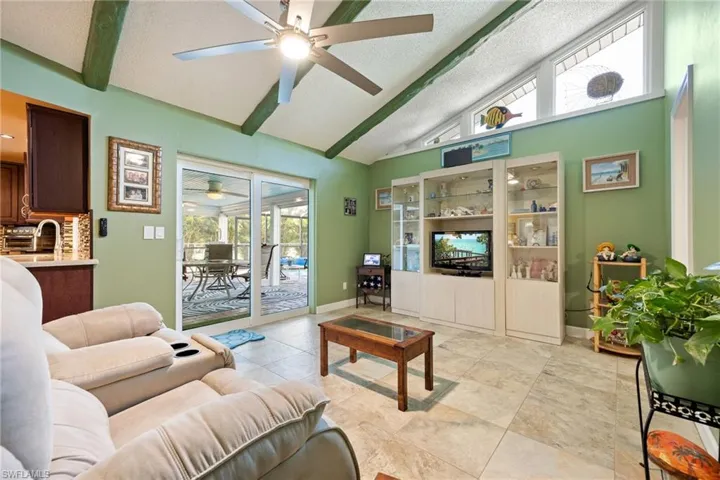 Welcoming Family Room with Vaulted Ceiling with Beams