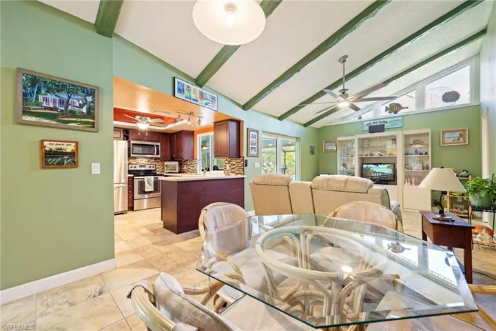 Dining area features vaulted ceiling with beams