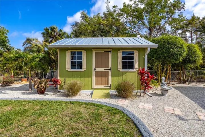 Storage shed with metal roof offers great space for lawn equipment